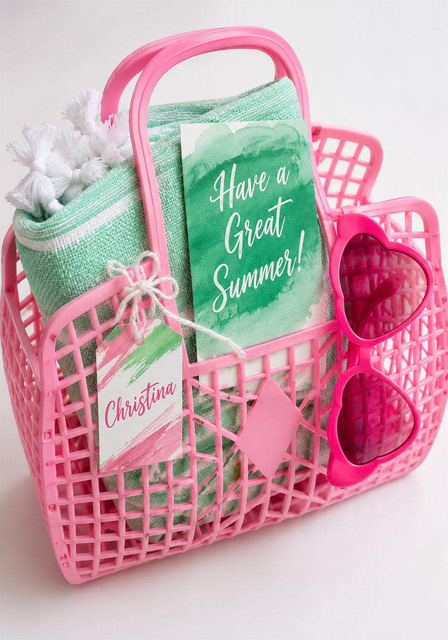 Personalized pink retro jelly tote favor bag filled with mint towel, pink sunglasses, and summer card for pool party guests
