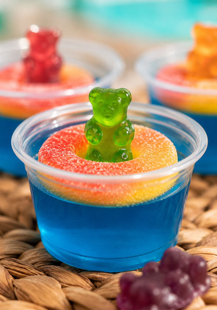 Pool party jello shots arranged on a serving tray at an outdoor summer party, ready to serve to guests