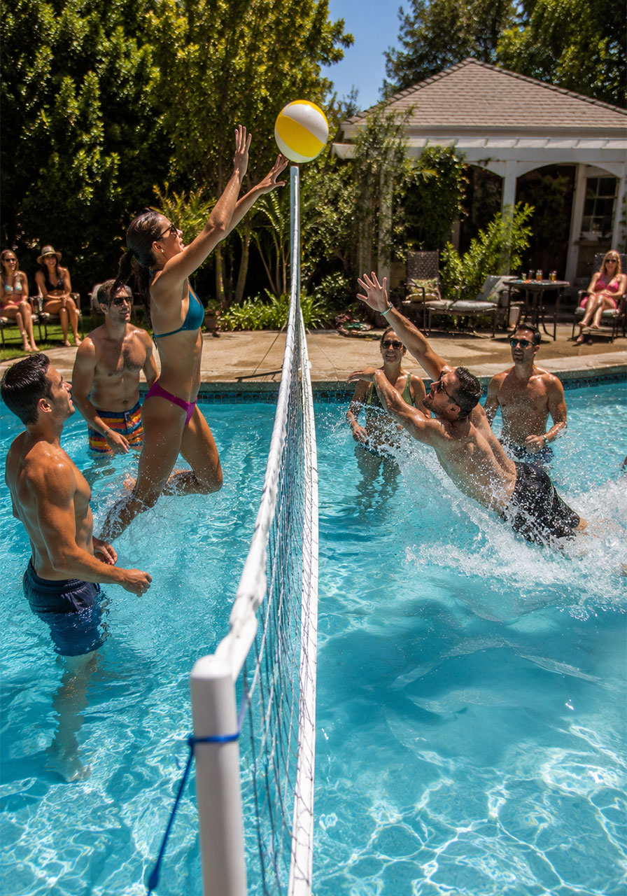 Adults playing pool volleyball in backyard pool with net spiking and diving during pool party game