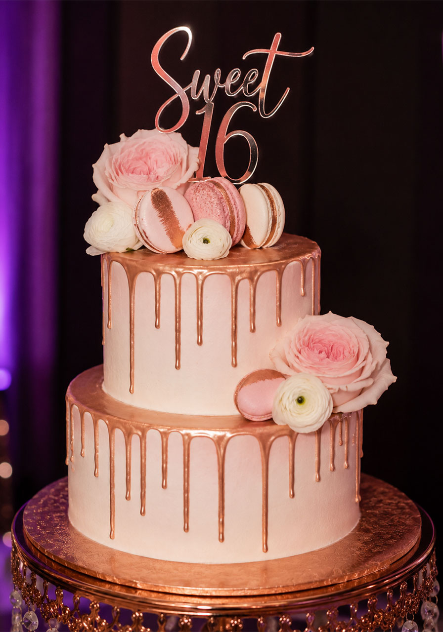 Rose gold drip birthday cake with macarons and fresh flowers for a Sweet 16 rose gold birthday party