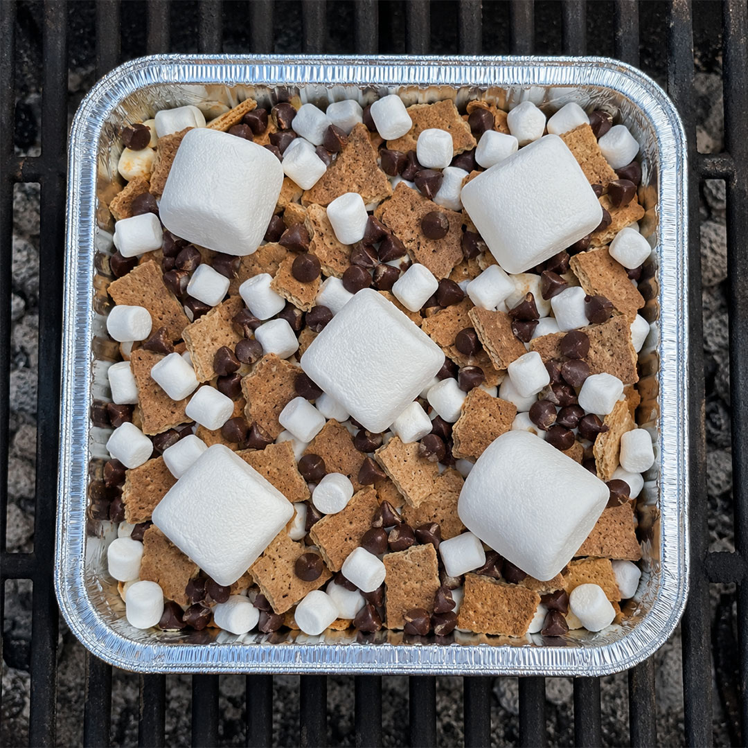 Fully assembled s'mores nachos foil pan ready to cook on the grill