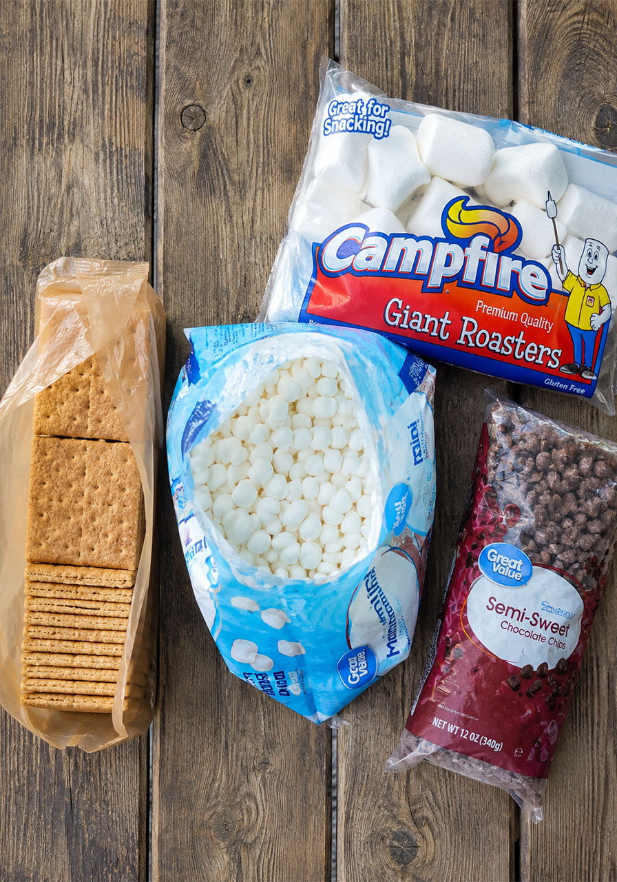Ingredients for s'mores nachos including graham crackers, marshmallows, and chocolate chips