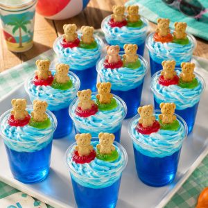 Tray of finished Swimming Bears Jello cups arranged for serving at a summer pool party – easy and adorable pool party dessert idea for kids and adults
