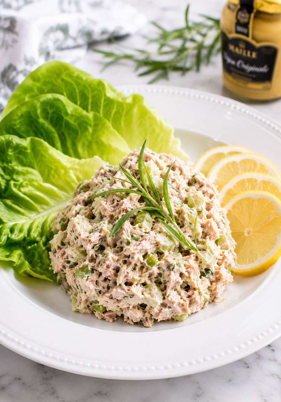 Tarragon tuna salad with fresh tarragon and lemon on a plate, a light and elegant no-cook summer lunch