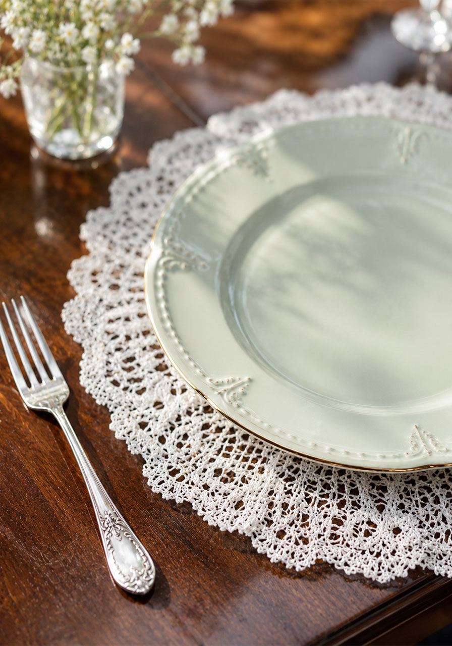 White lace doily charger plate used as an elegant tea party table accent