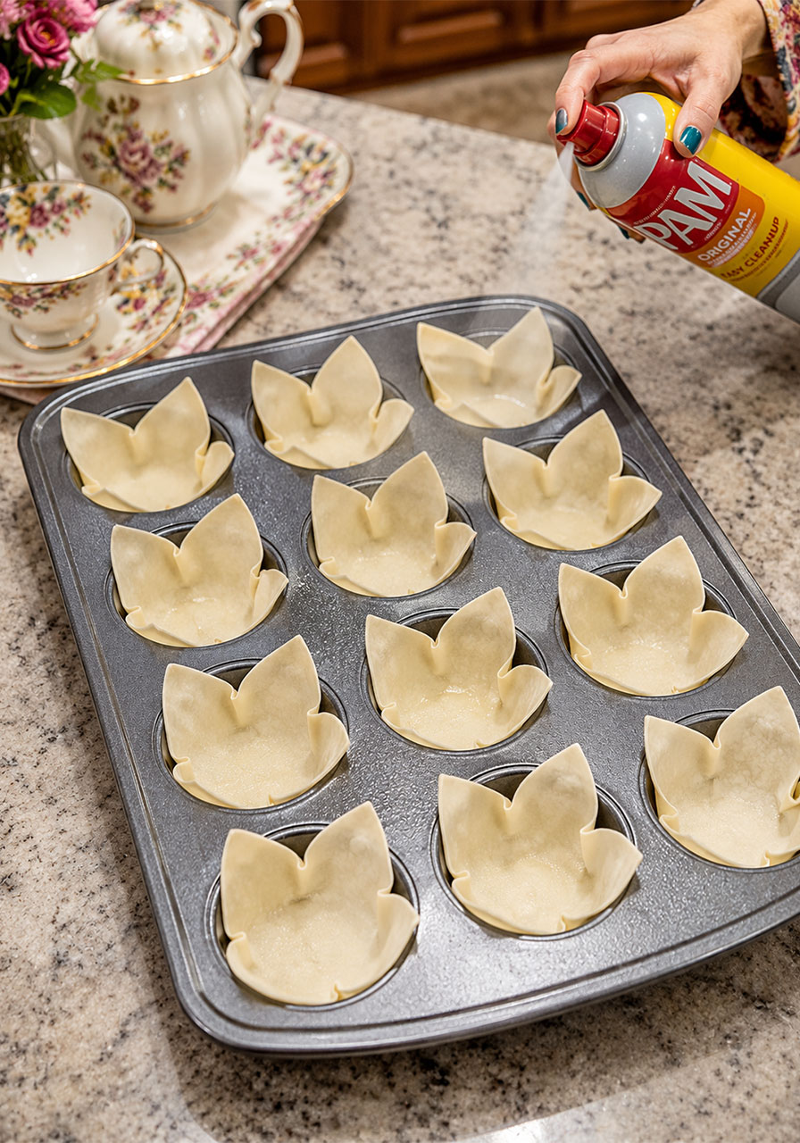 Wonton wrappers pressed into muffin tin cups and sprayed with cooking spray before pre-baking