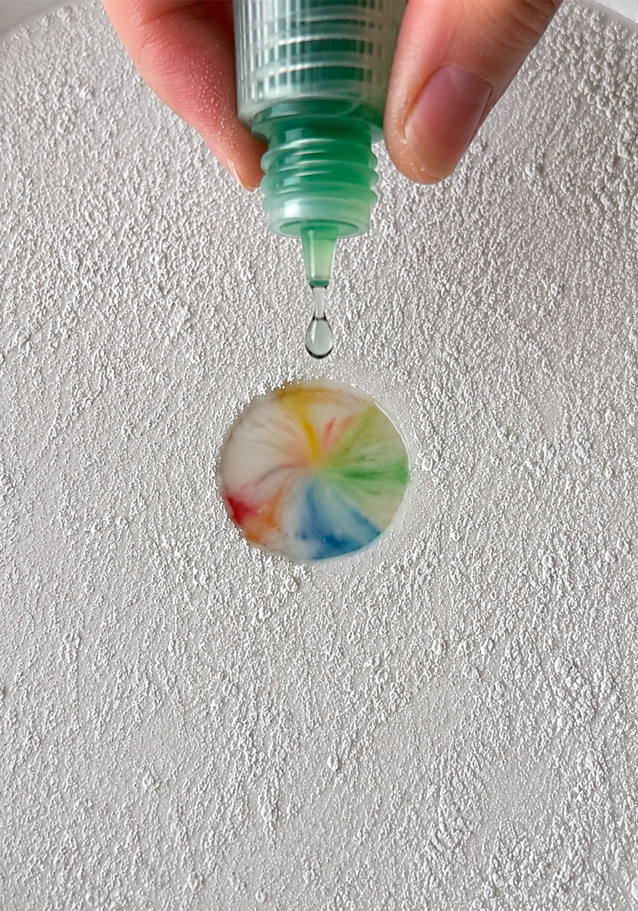 Step 4: adding a drop of dish soap to trigger the milk color explosion reaction