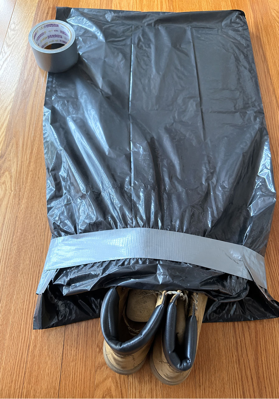 Work boots taped inside contractor bag to form the feet of a Halloween body prop