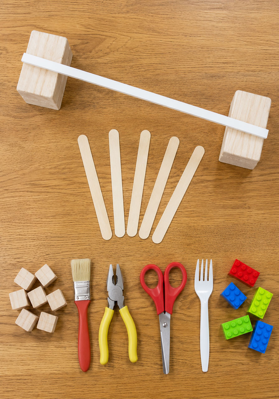 Supplies needed for balancing craft sticks STEM challenge including dowel rod and craft sticks