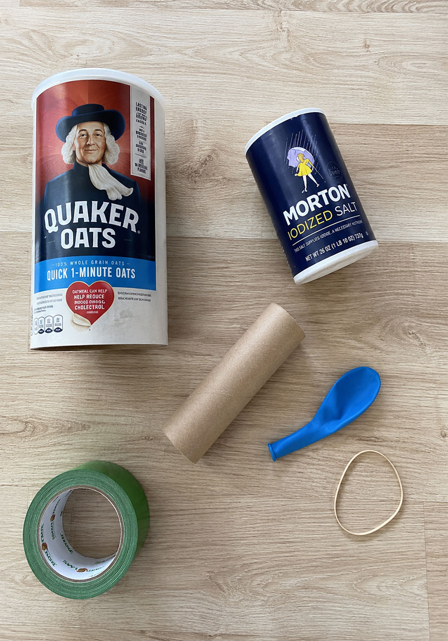 Materials needed for a DIY Chladni plate: oatmeal canister, balloon, tube, tape, salt