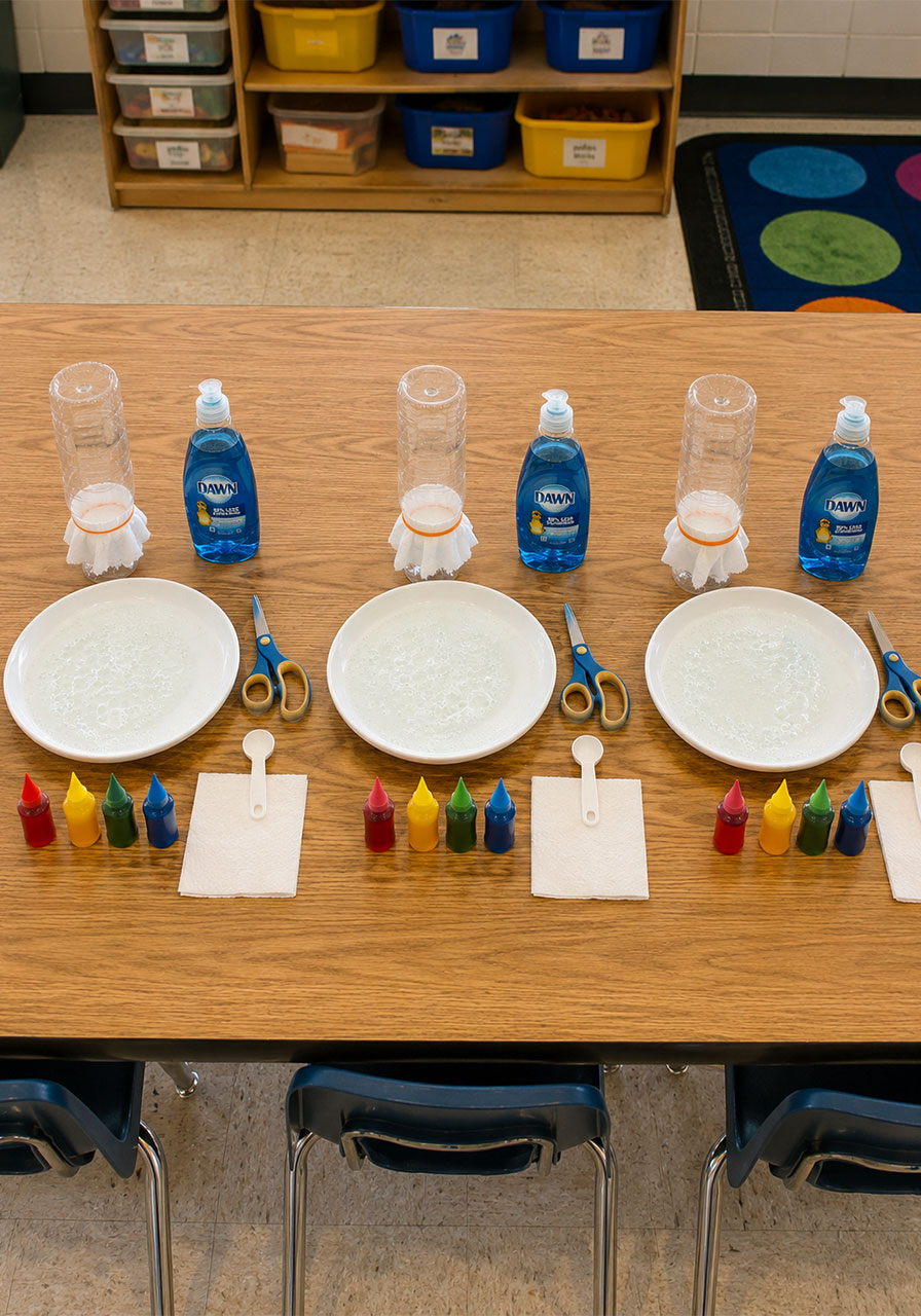 Classroom setup with multiple bubble snake STEM stations for group activity