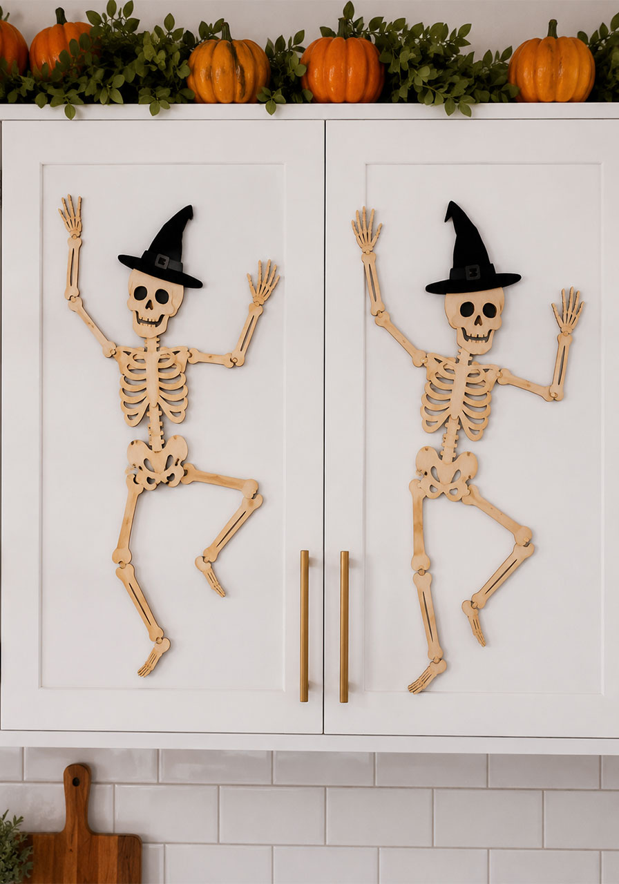 Wooden skeleton cutouts in dancing poses decorating white kitchen cabinet doors for Halloween