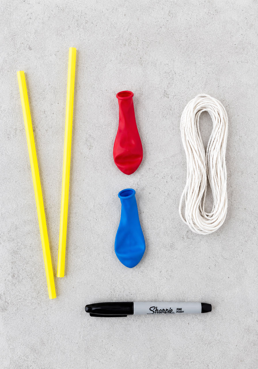 Materials needed for a DIY balloon rocket experiment: balloons, straws, string, and a marker
