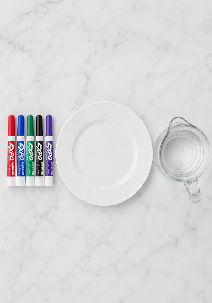 Materials needed for floating ink experiment: dry erase markers, plate, and water