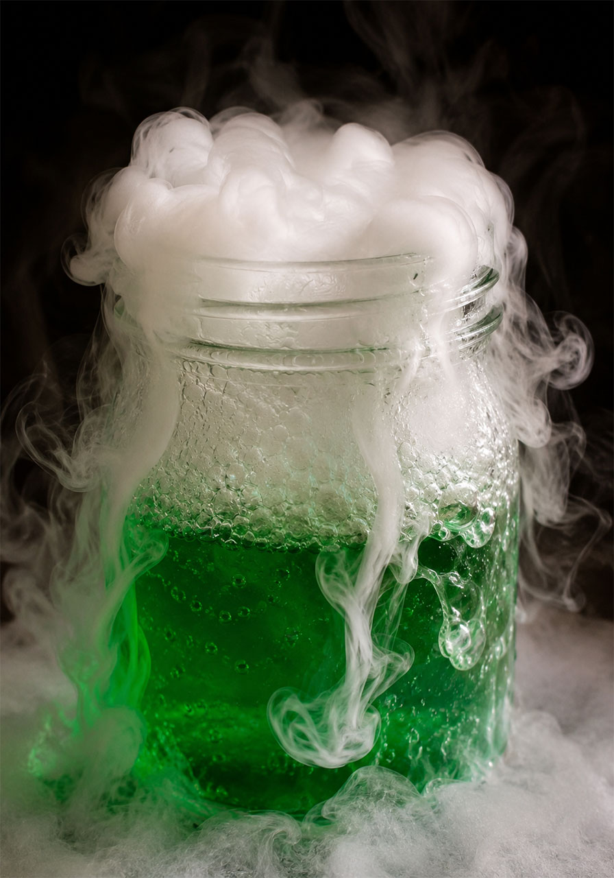 Close-up of dry ice sublimation creating fog and bubbles in a Halloween science experiment