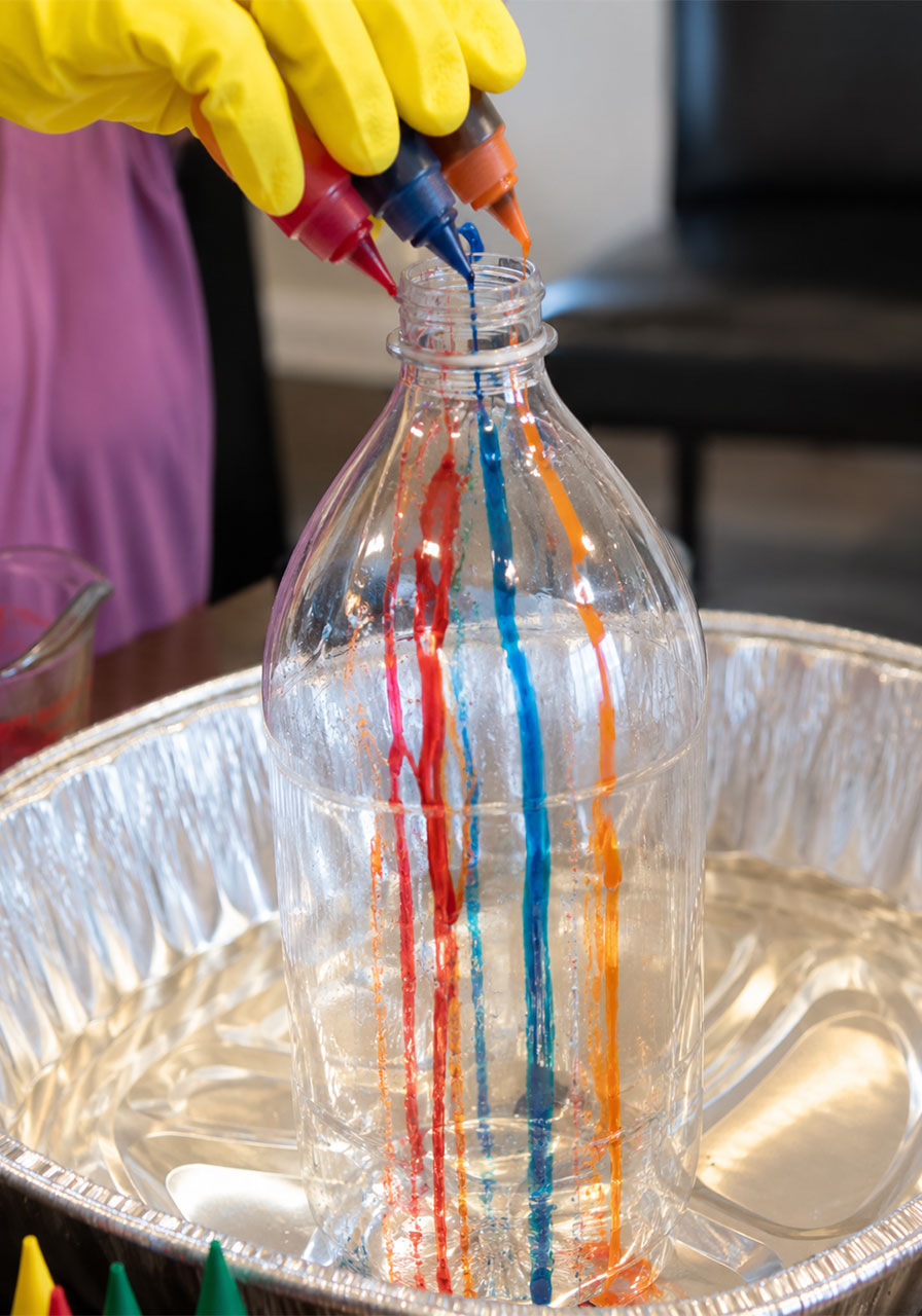Adding colorful food coloring stripes inside bottle before foam reaction