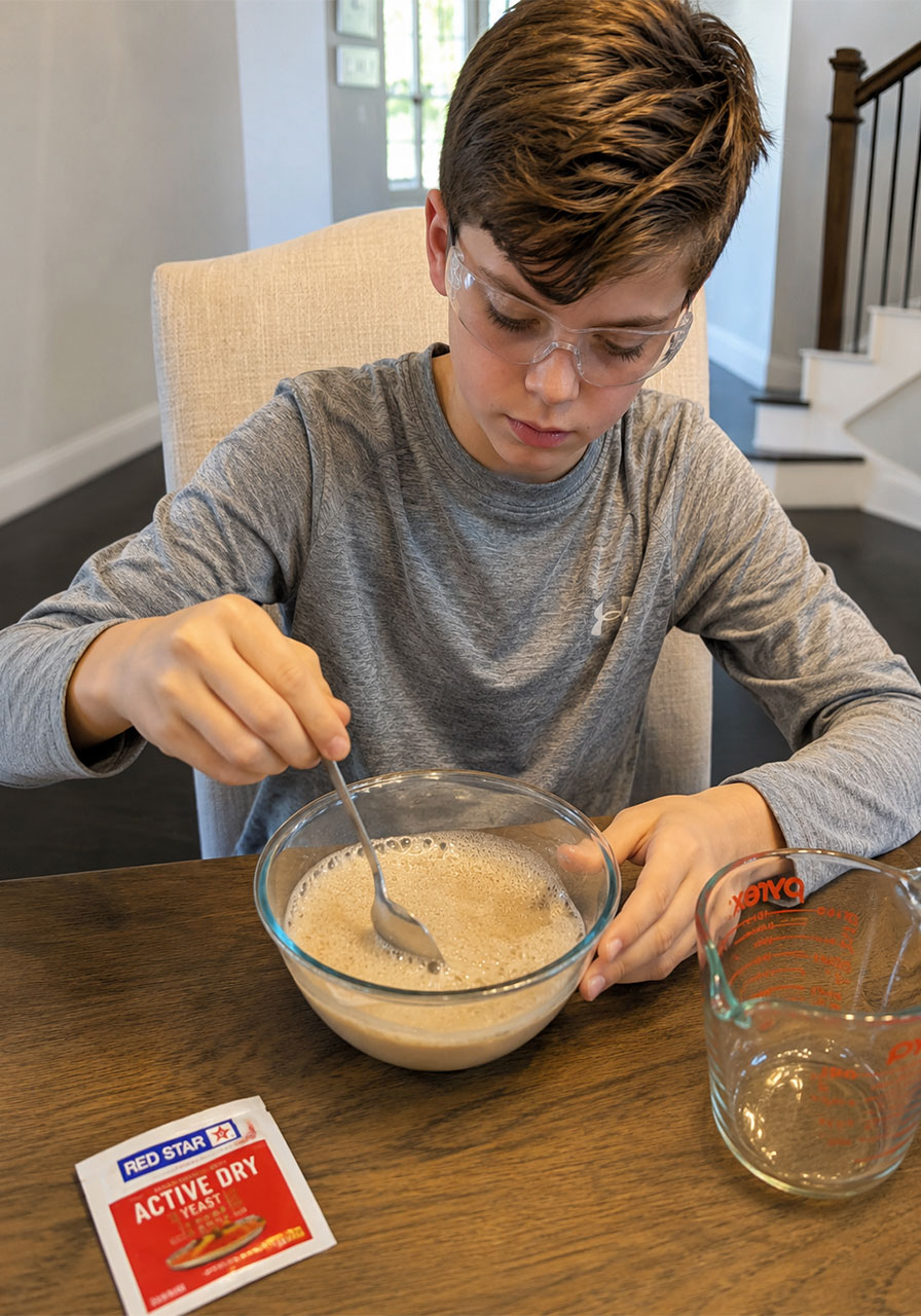Mixing active dry yeast with warm water to activate catalyst for experiment