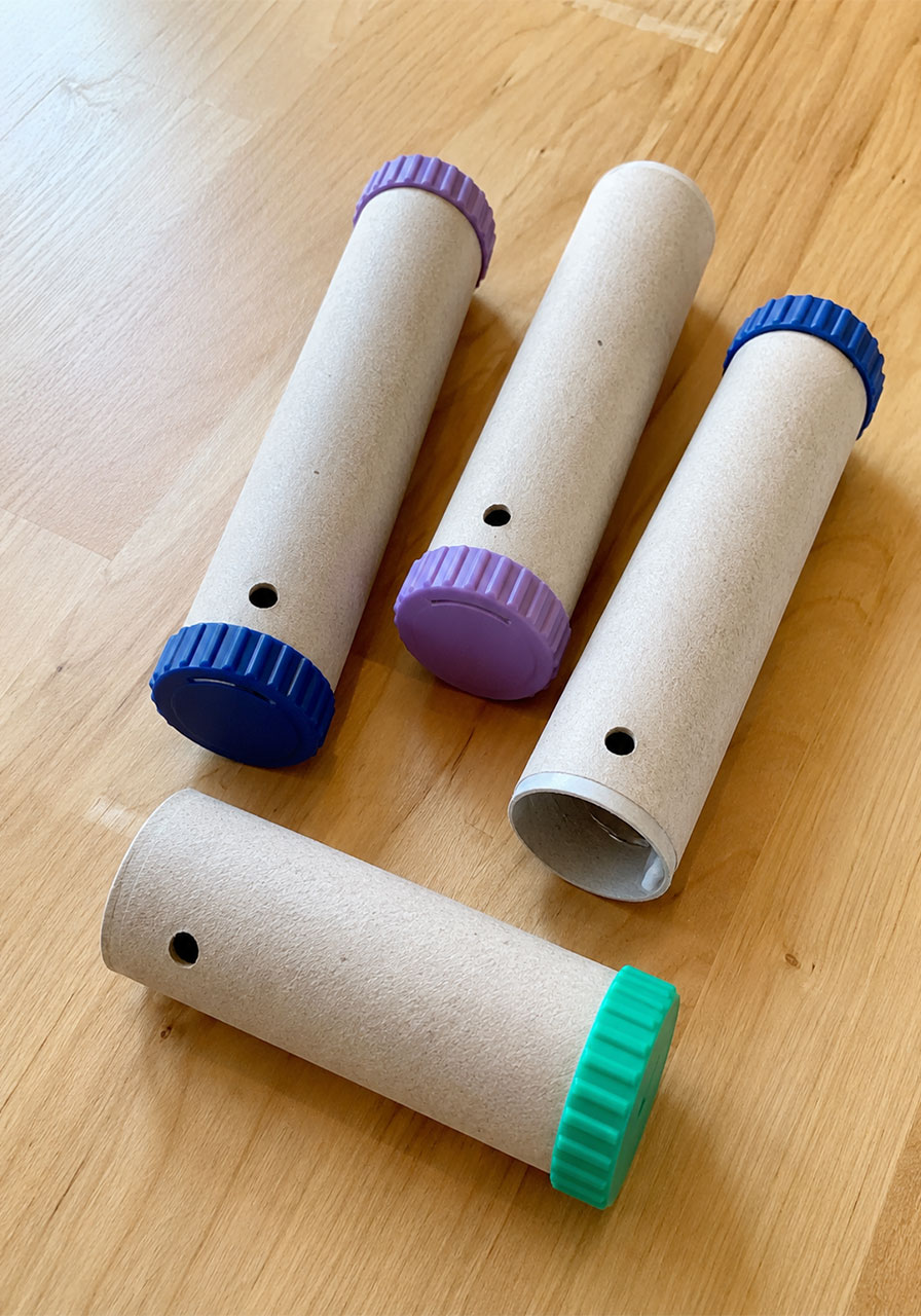 Four completed cardboard spectrometers with colorful twist caps ready to use
