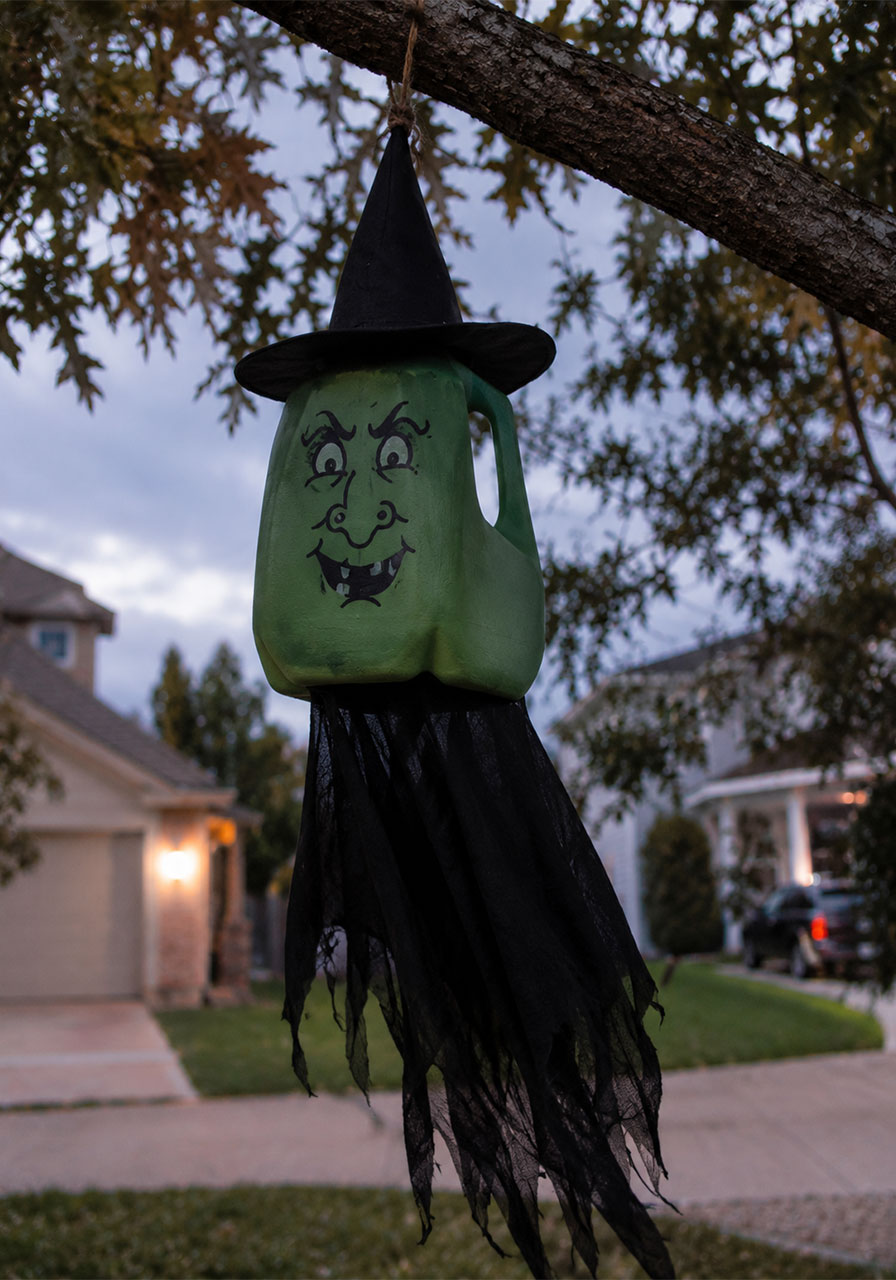 DIY flying milk jug witch Halloween yard decoration