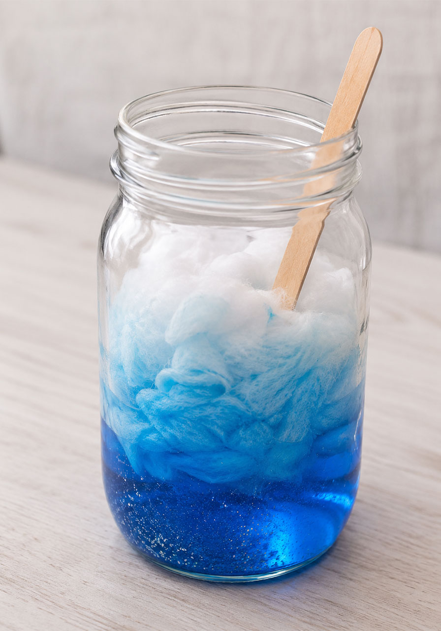 Cotton balls absorbing blue colored water showing absorption science for kids