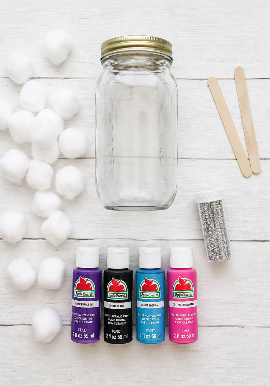 Materials needed for galaxy jar craft including mason jar paint and cotton balls