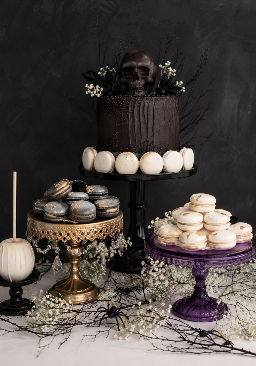 Black and white gothic dessert table with skull cake for Halloween party