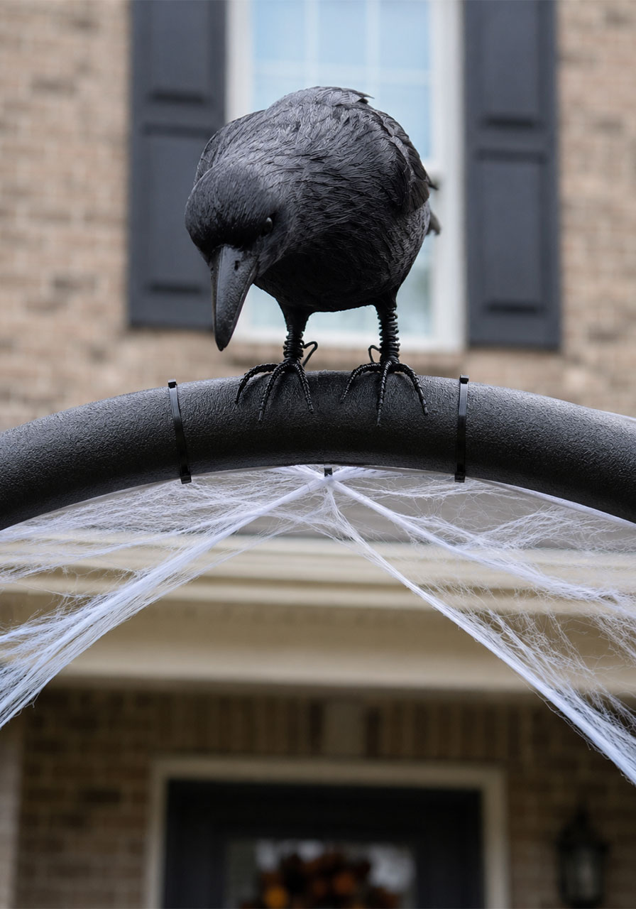 Black crow decoration perched on top of a DIY Halloween archway