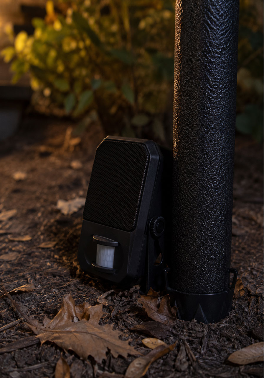 Motion-activated sound speaker hidden at the base of a Halloween archway