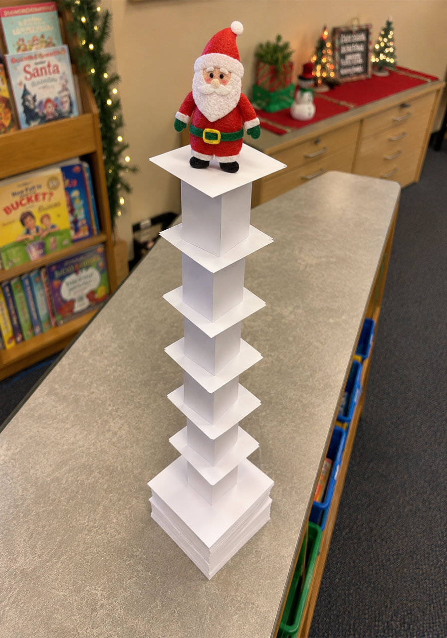 Christmas-themed index card tower STEM challenge with Santa topper