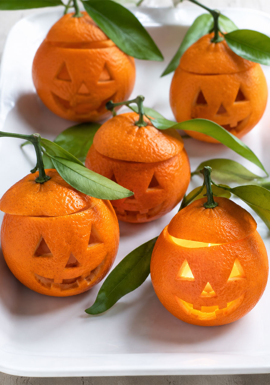 Jack-o'-lantern ideas: tiny carved tangerine lanterns for a Halloween party tray