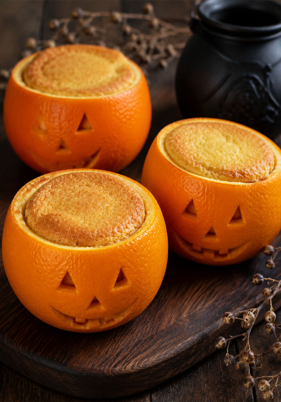 Jack-o'-lantern ideas: mini cakes baked in carved orange shells for Halloween dessert