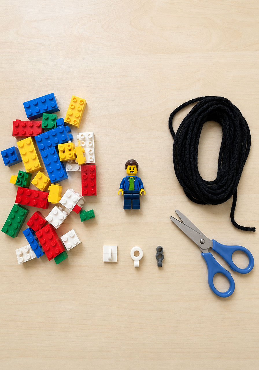 Materials needed for a LEGO zip line STEM activity including bricks minifigure and string