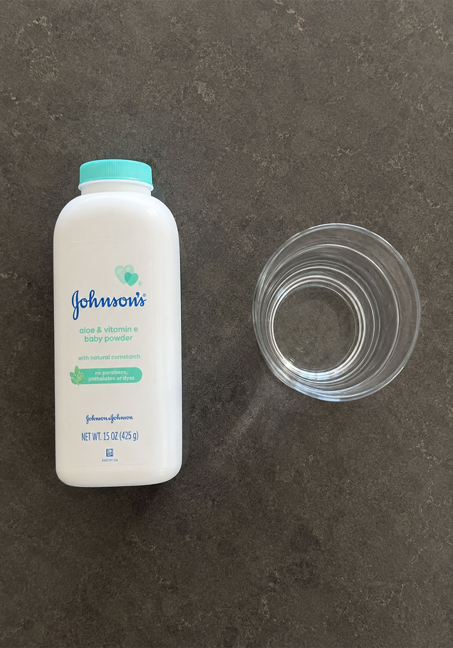 The only two materials needed for the Magic Powder Shield experiment: baby powder and a glass of water