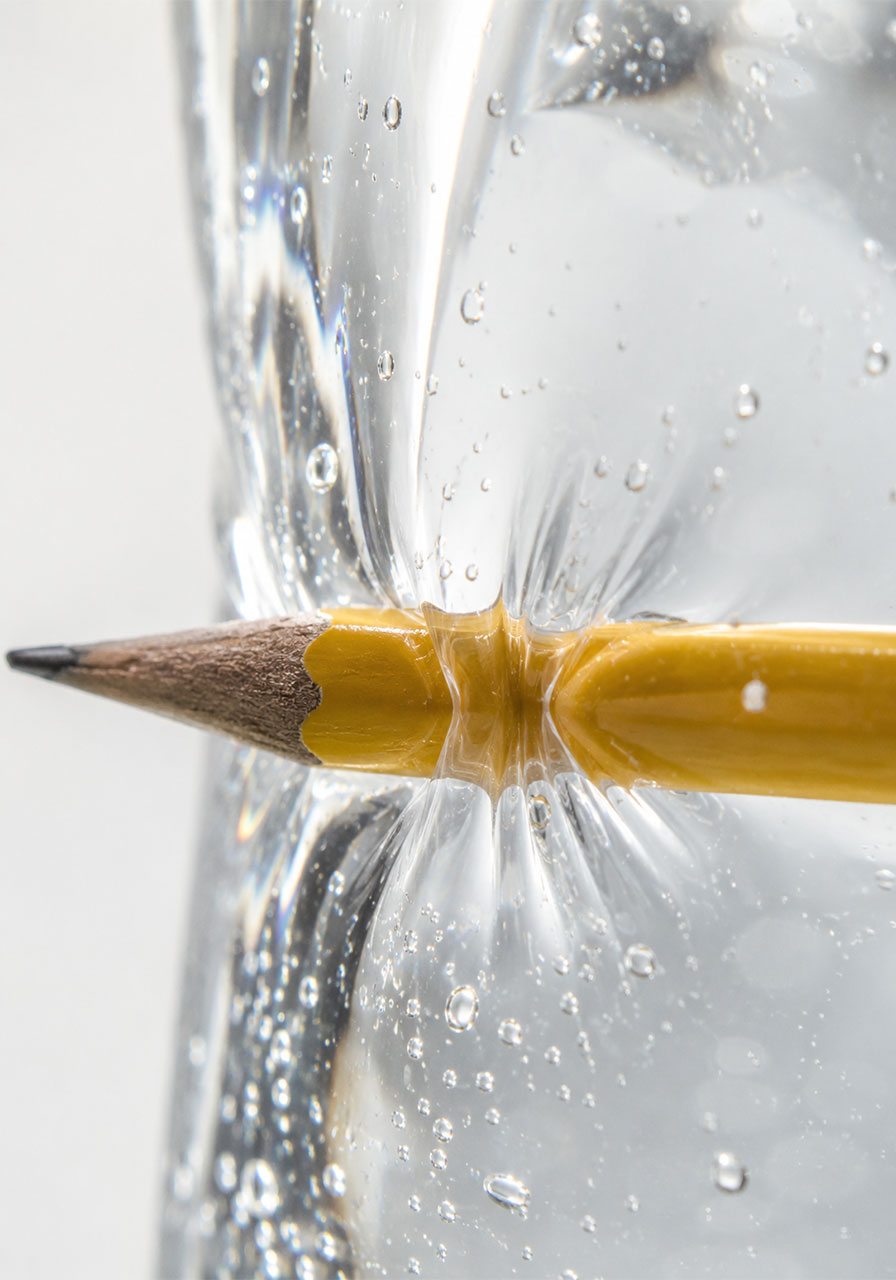 Close-up of plastic polymer chains sealing tightly around a pencil in the water bag experiment