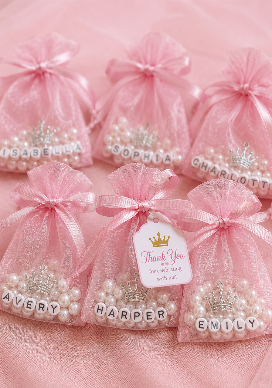 Sparkly pink organza favor bags with pearls and charms for princess birthday party guests