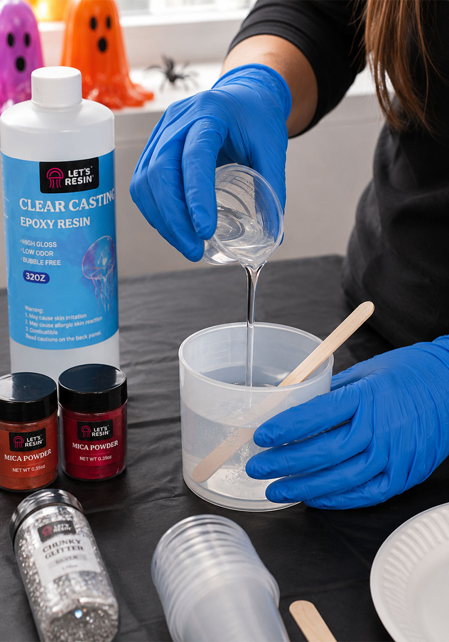 Hands mixing epoxy resin and hardener for resin ghost craft