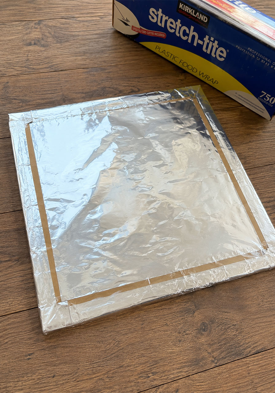 Aluminum foil reflector glued onto a solar oven flap