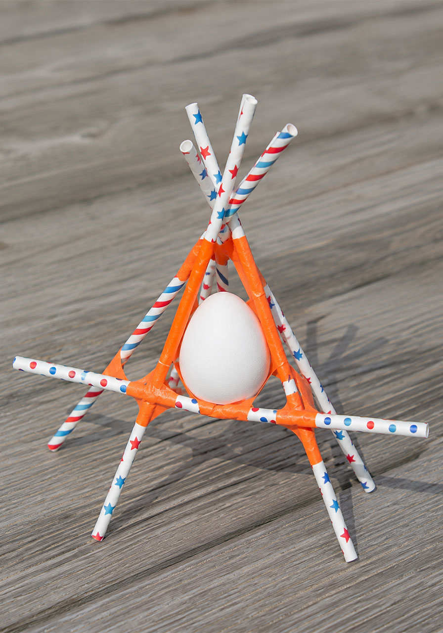 Straw pyramid egg drop STEM contraption designed to protect an egg from a high fall