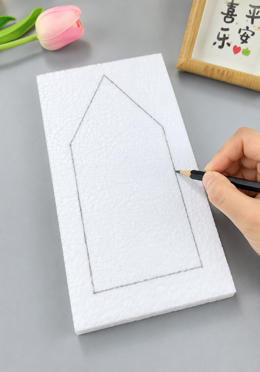 Tracing a simple house shaped outline onto foam board to create the STEM boat hull