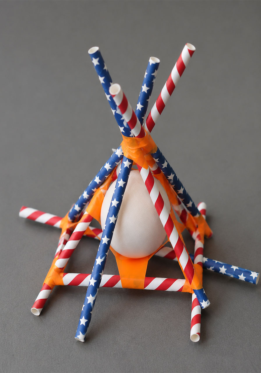 Straw pyramid cage design for protecting an egg during the drop test