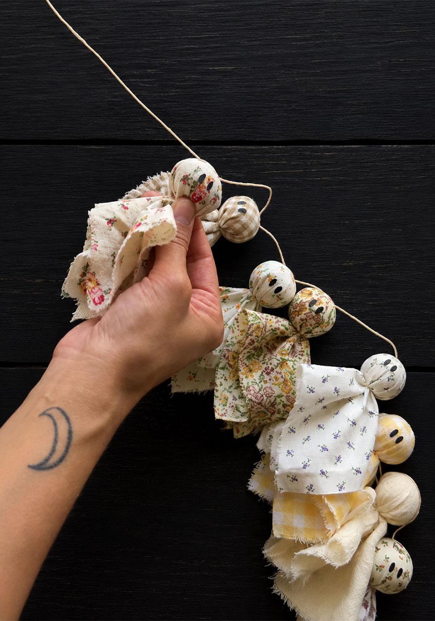 Stringing finished fabric ghosts onto twine to build the garland step6b