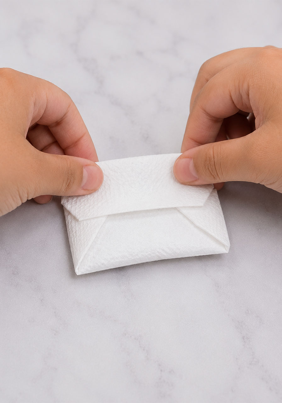 Wrapping baking soda in a paper towel packet for the monster science experiment